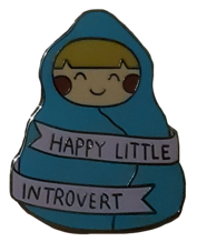 pin of a person in a blanket saying happy little introvert